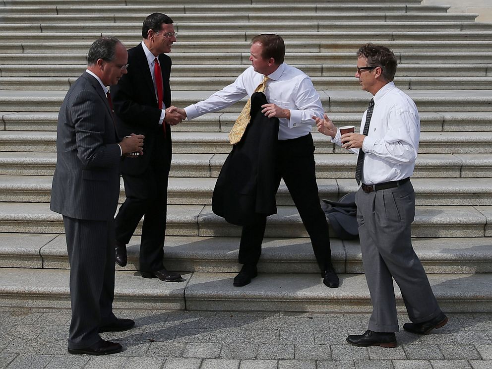PHOTO: Rep. Rep. Mick Mulvaney (R-SC), Sen. John Barrasso (R-KY), Rep. Brett Guthrie (R-KY) and Sen. Rand Paul (R-KY) take a coffee break on the Senate steps at the U.S. Capitol October 3, 2013 in Washington, DC.