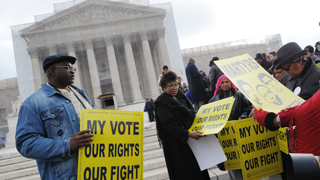 PHOTO: Activists distribute pro-voting rights placards outside of the US Supreme Court, Feb. 27, 2013 in Washington.