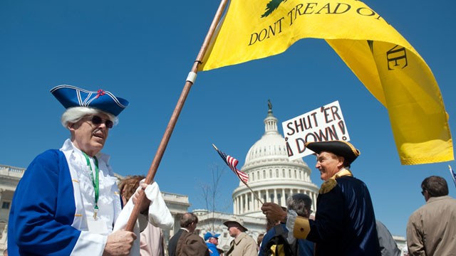 PHOTO: Tea party activists Bob Mason, left and John Oltesvig, both of North Carolina, wear colonial costumes with tri-corner hats as they participate in the rally at the Capitol, April 6, 2012.