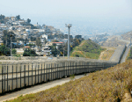 A fence runs along the US-Mexico border between the Otay Mesa and San Ysidro ports of entry in and near San Diego, Calif., across from Tijuana, Mexico, April 4, 2013.
