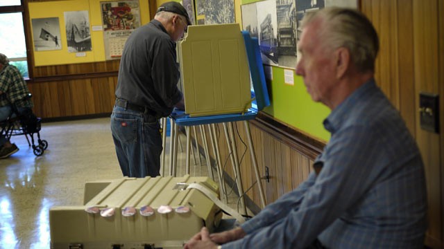PHOTO: Election Official Glenn Weideman, right, waits to collect a ballot from voters during early morning voting in the Wisconsin recall election at the Beloit Historical Society on June 5, 2012 in Beloit, Wisconsin.