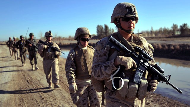 PHOTO: US Marine servicewomen from 2nd Battalion, 1st Marines Golf Company patrol in Basabad, Helmand Province, Afganistan, March 9, 2011.