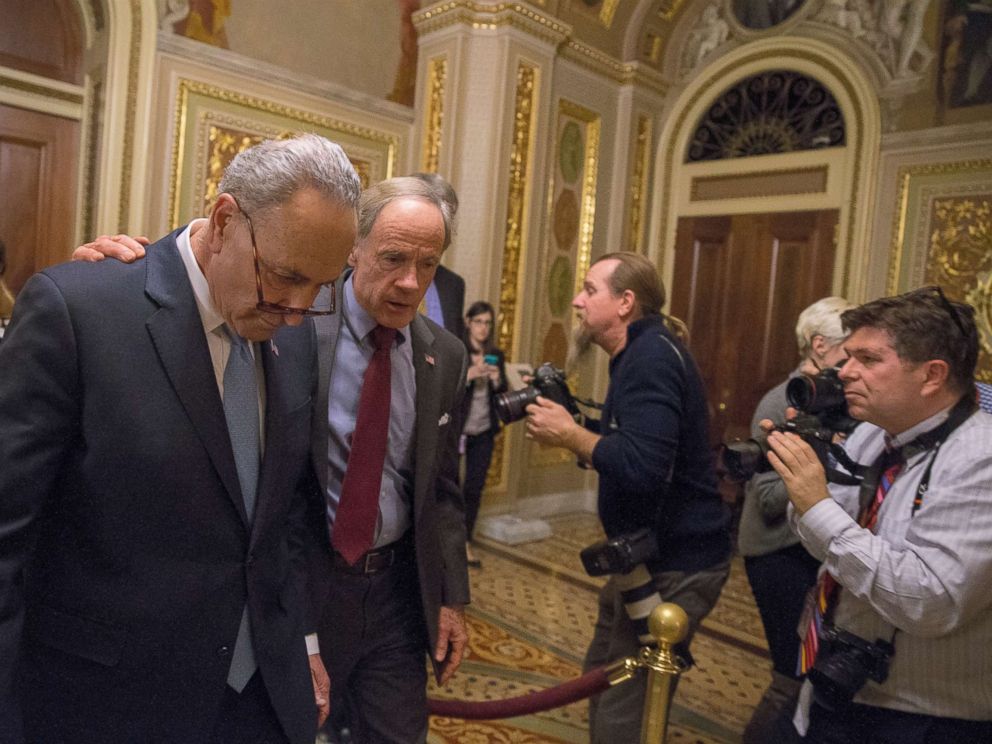 PHOTO: WASHINGTON, DC - JANUARY 19: (L-R) Senate Minority Leader Chuck Schumer (D-NY) and Senator Tom Carper (D-DE) walk out of a Democratic Caucus meeting at the US Capitol on January 19, 2018 in Washington, DC.