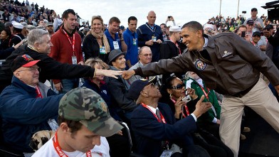 PHOTO: President Barack Obama greets veterans before the Carrier Classic basketball game between the University of North Carolina Tar Heels