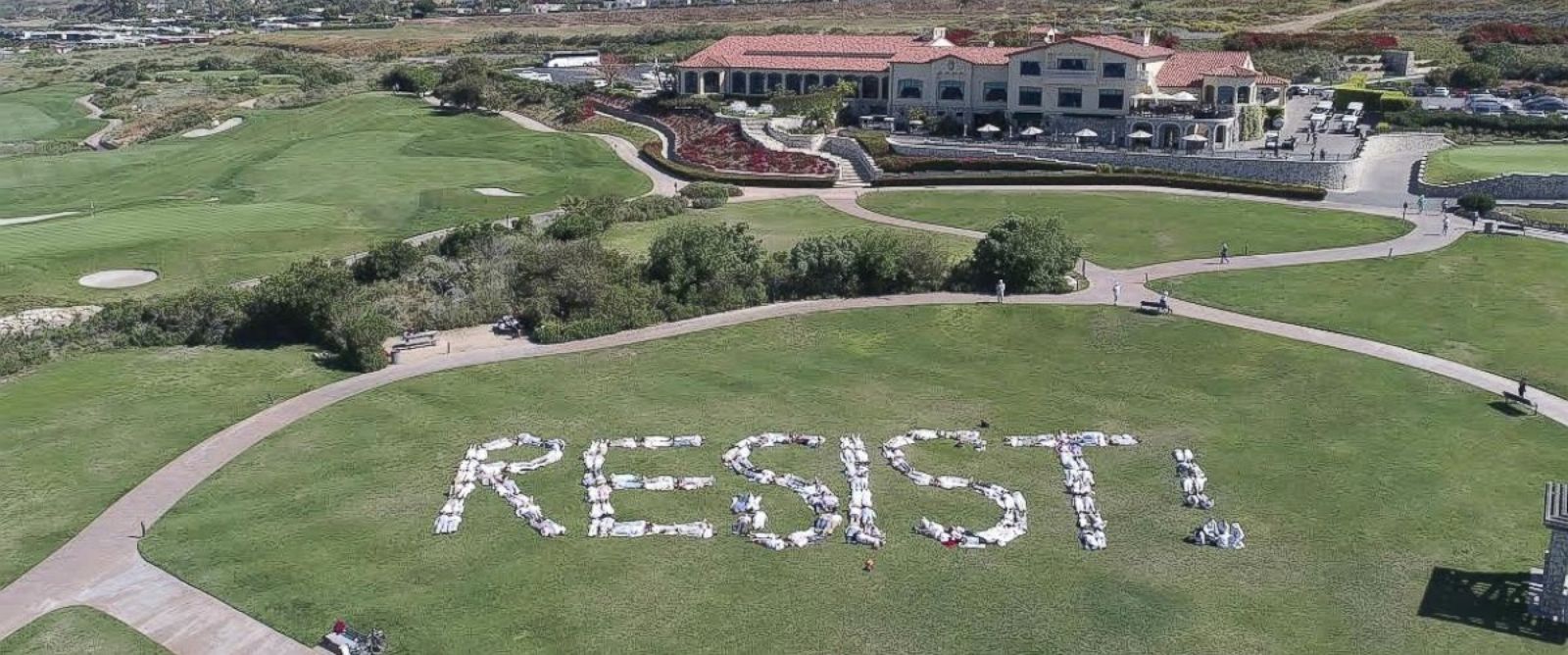PHOTO: About 200 protesters, part of the group Indivisible San Pedro, spelled out the word "RESIST!" on the ground of the Trump National Golf Club in Rancho Palos Verdes, California, on May 13, 2017.