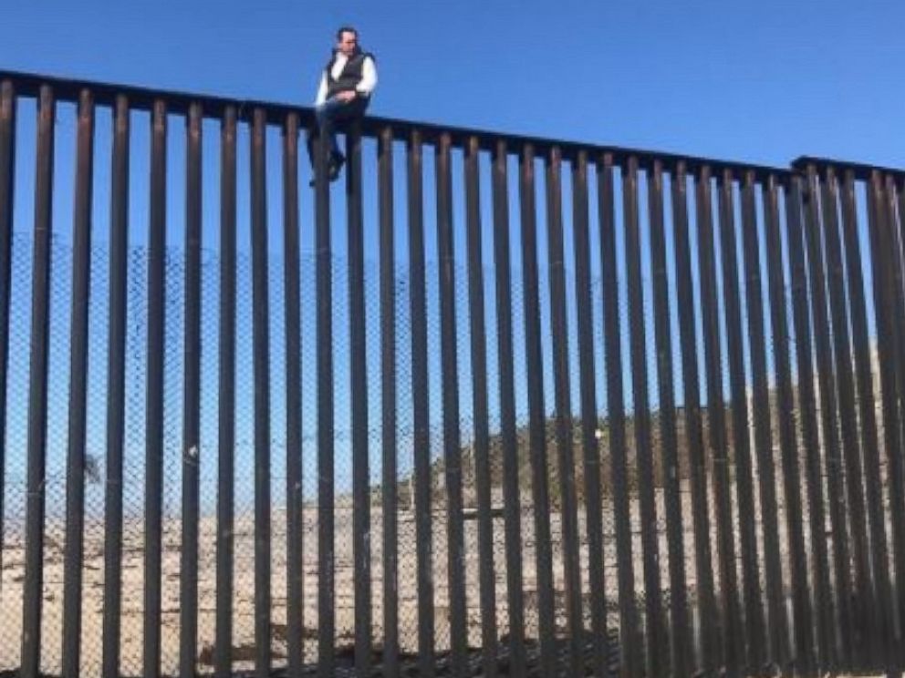 PHOTO: Mexican congressman Braulio Guerra sits atop the U.S.-Mexico border wall that divides Tijuana, Mexico, from California on March 1, 2017.
