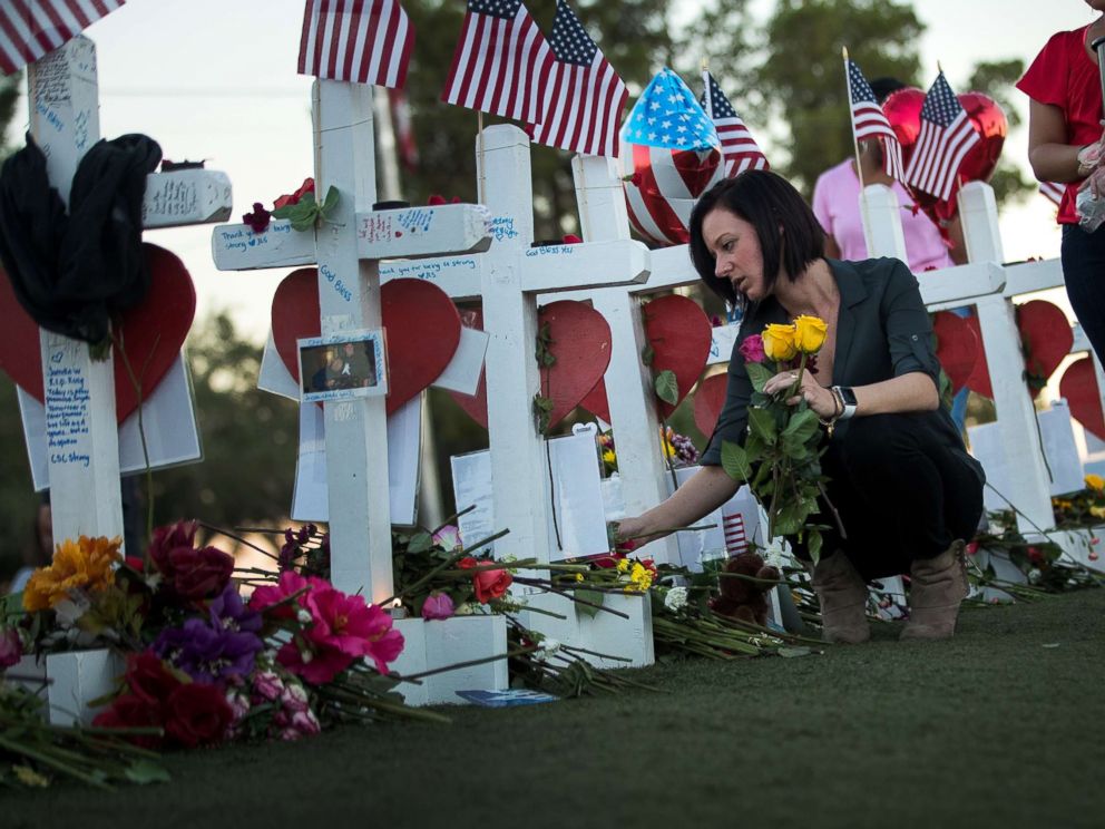 PHOTO: Antoinette Cannon, who worked as a trauma nurse and treated victims last Sunday night, leaves a rose at each of the 58 white crosses at a makeshift memorial on the south end of the Las Vegas Strip, Oct. 6, 2017 in Las Vegas, Nevada.