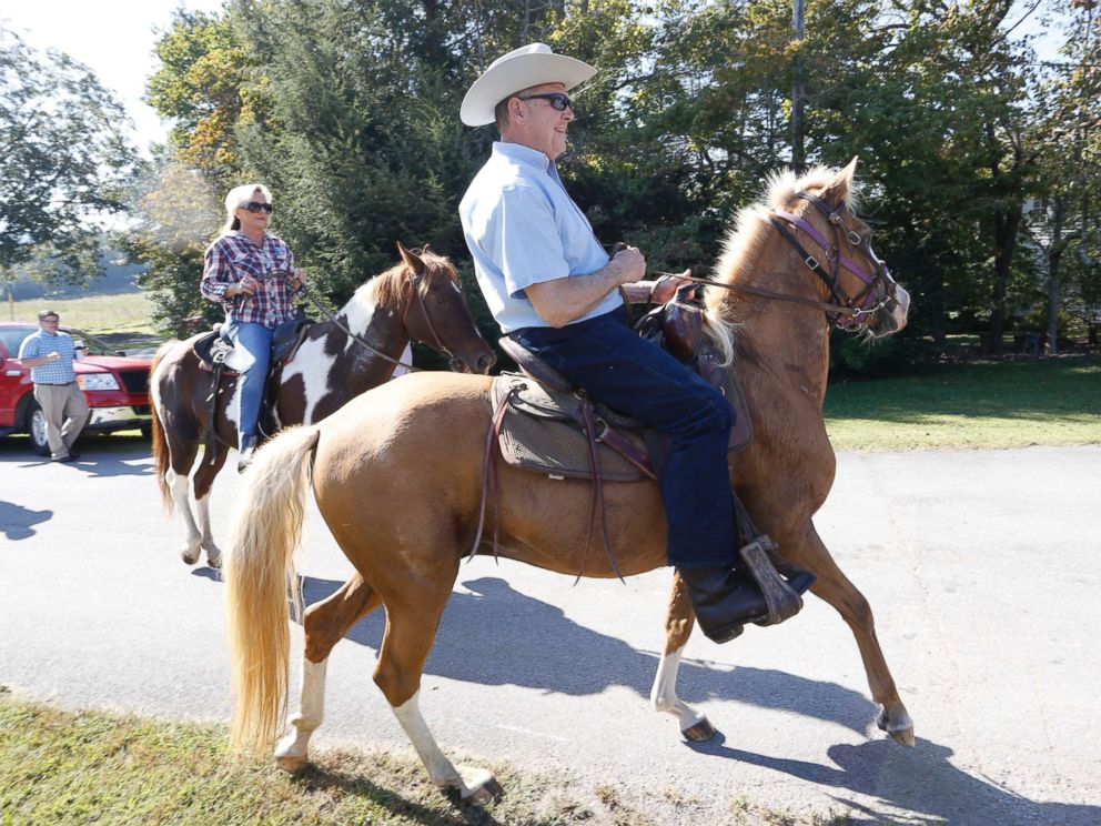 PHOTO: Alabama Republican U.S. Senate candidate Roy Moore on Sassy and wife Kayla on Sundance ride their horses to the Gallant Fire Hall to vote in the GOP runoff election Sept. 26, 2017 in Gallant, Ala.