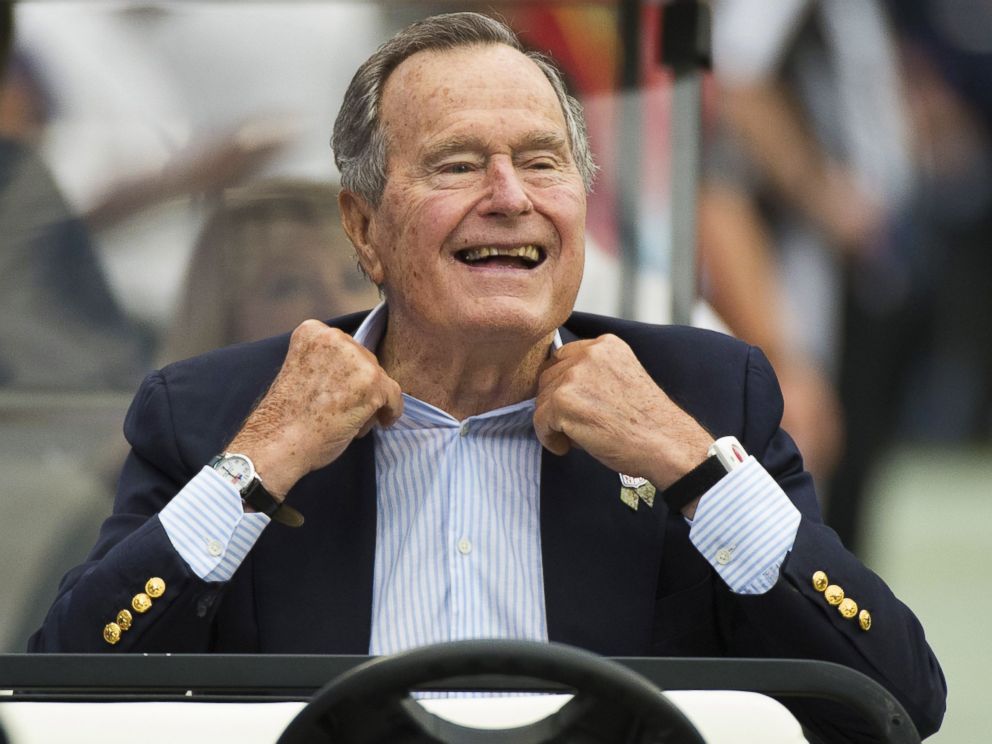 PHOTO: Former President George H.W. Bush sits on the sidelines before a game between the Houston Texans and Oakland Raiders, in Houston, in this Nov. 17, 2013 photo.