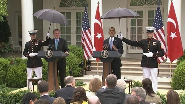 VIDEO: The president enlists the help of Marines to hold umbrellas during Rose Garden press conference.