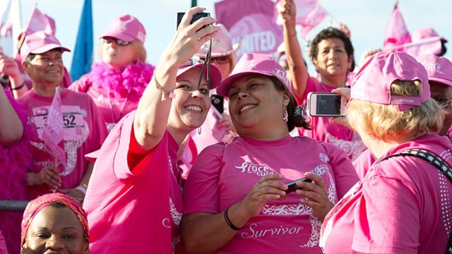 PHOTO: Breast cancer survivors take pictures of each other during the Susan G. Komen Foundations 2012 Race for the Cure in Washington, June 2, 2012.