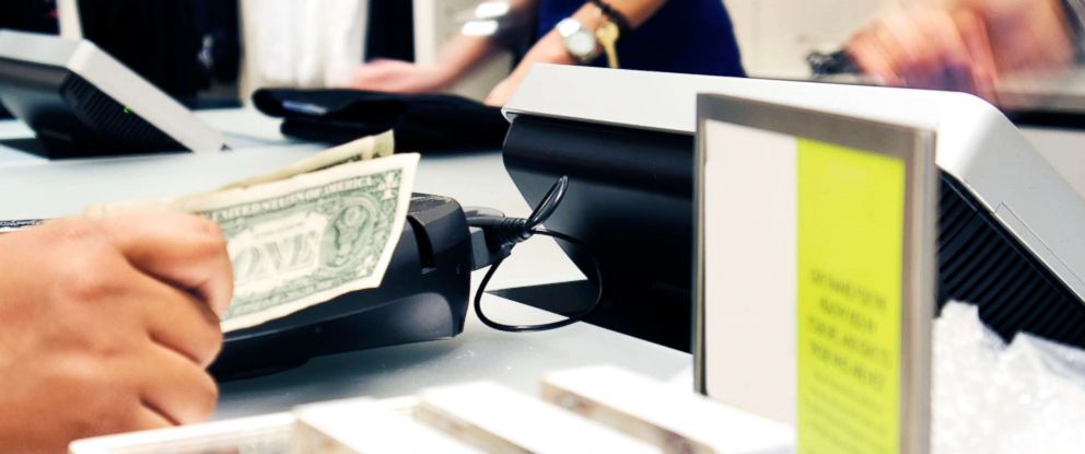 PHOTO: A customer pays for a purchase in a clothing store in this undated stock photo.