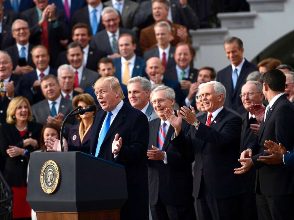 PHOTO: Surrounded by Republican Senators and House Representatives, President Donald Trump speaks about the passage of tax reform legislation on the South Lawn of the White House, December 20, 2017.