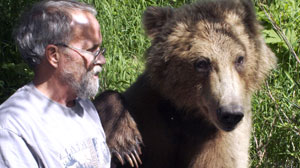 Grizzly with paw on Charlies shoulder