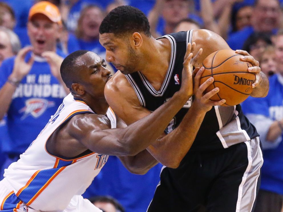 PHOTO: Oklahoma City Thunder forward Serge Ibaka reaches in to try and take the ball away from San Antonio Spurs forward Tim Duncan at he Western Conference finals NBA basketball playoff series in Oklahoma City, May 27, 2014.