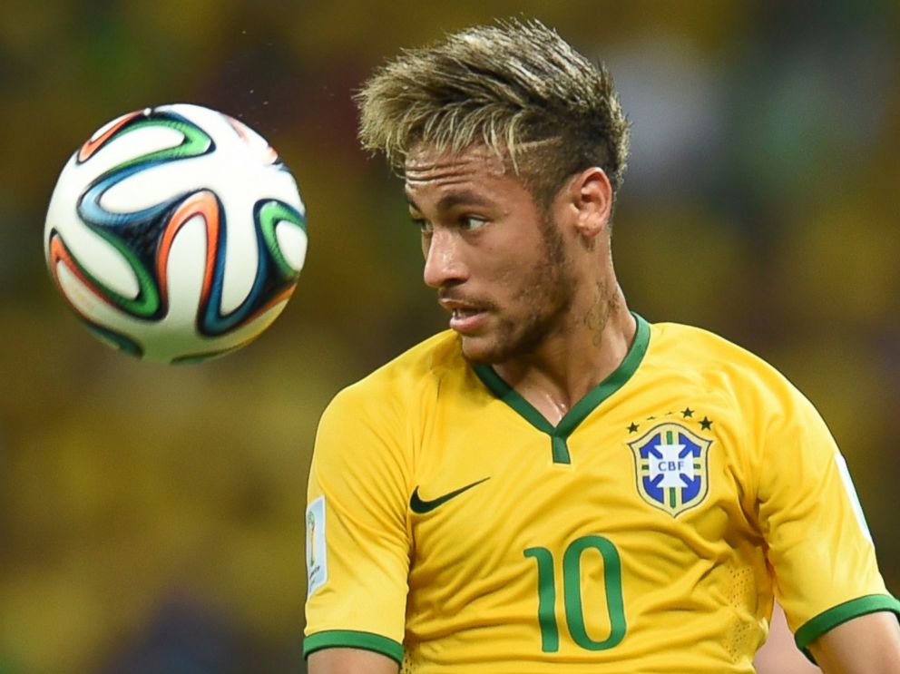 PHOTO: Brazils forward Neymar eyes the ball during the quarter-final match between Brazil and Colombia during the 2014 FIFA World Cup in Fortaleza, Brazil on July 4, 2014.