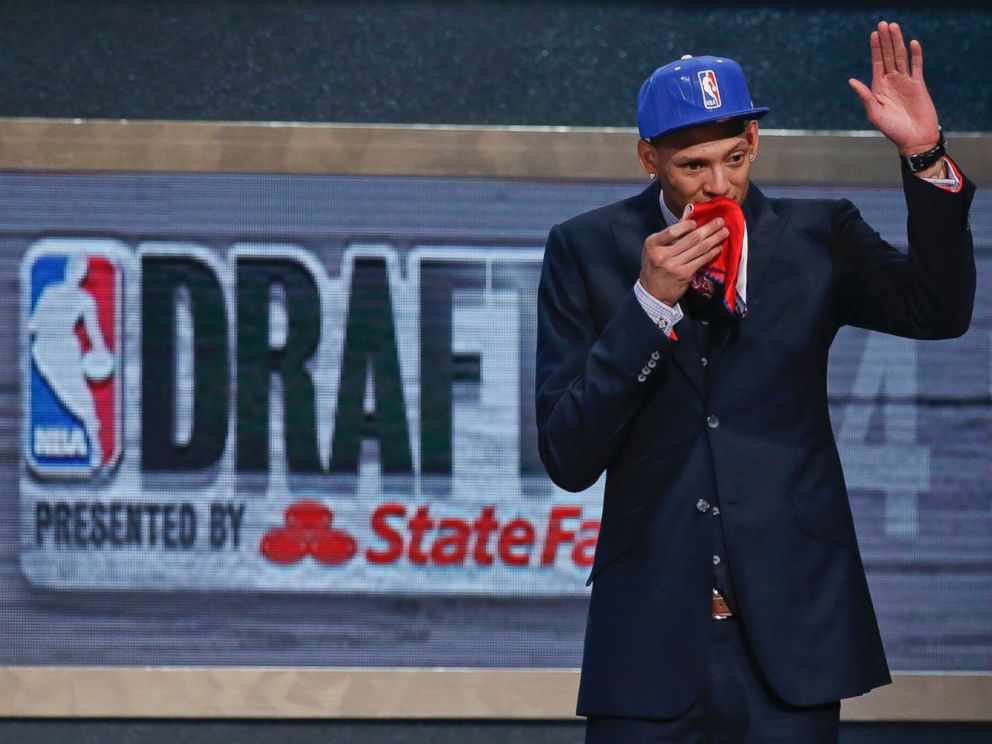 PHOTO: Baylor center Isaiah Austin waves to the crowd after being granted a ceremonial first round pick during the 2014 NBA Draft, June 26, 2014, in New York.