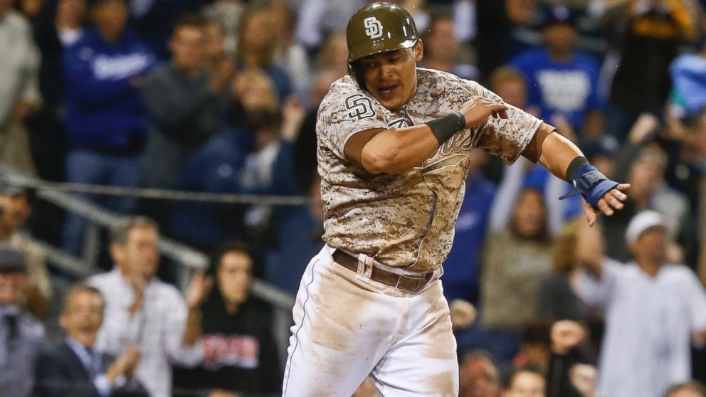 PHOTO: San Diego Padres Everth Cabrera leaps in joy after scoring against the Los Angeles Dodgers in the eighth inning of the opening game of Major League baseball in the United States Sunday, March 30, 2014, in San Diego.