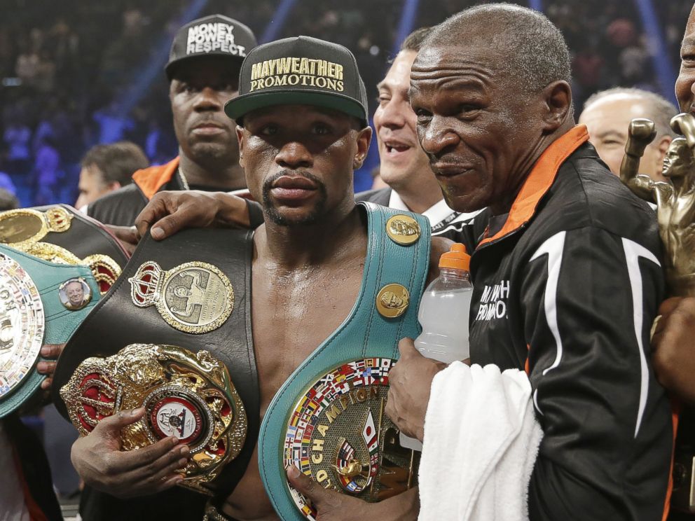 PHOTO: Floyd Mayweather Jr., left, poses with his champions belts and his father, head trainer Floyd Mayweather Sr., after his victory over Manny Pacquiao, from the Philippines, in their welterweight title fight on Saturday, May 2, 2015 in Las Vegas.