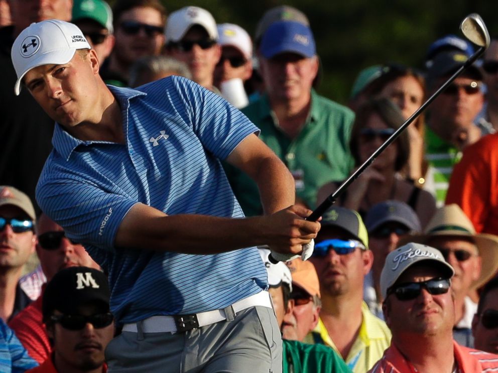 Jordan Spieth hits out of the gallery on the 18th hole during the third round of the Masters golf tournament Saturday, April 11, 2015, in Augusta, Ga.