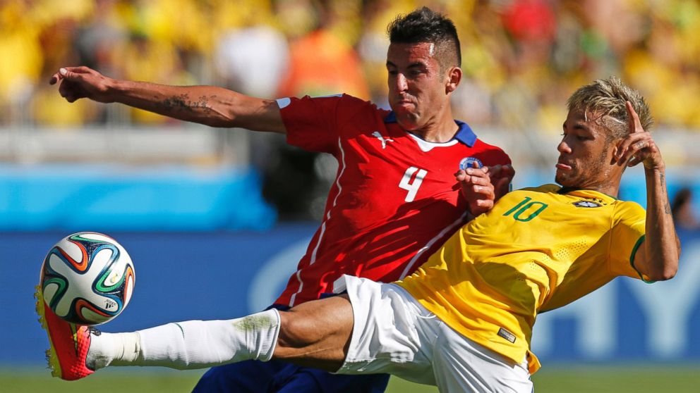 PHOTO: Brazils Neymar, right, fights for the ball with Chiles Mauricio Isla during their World Cup round of 16 soccer match at Mineirao Stadium in Belo Horizonte, Brazil, June 28, 2014.