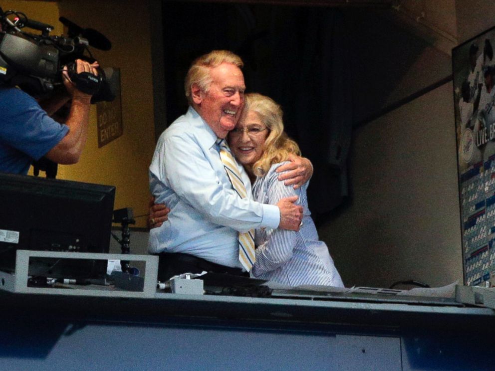 PHOTO: Broadcaster Vin Scully, left, embraces his wife, Sandra, after his 2015 return was announced, July 29, 2014, in Los Angeles.