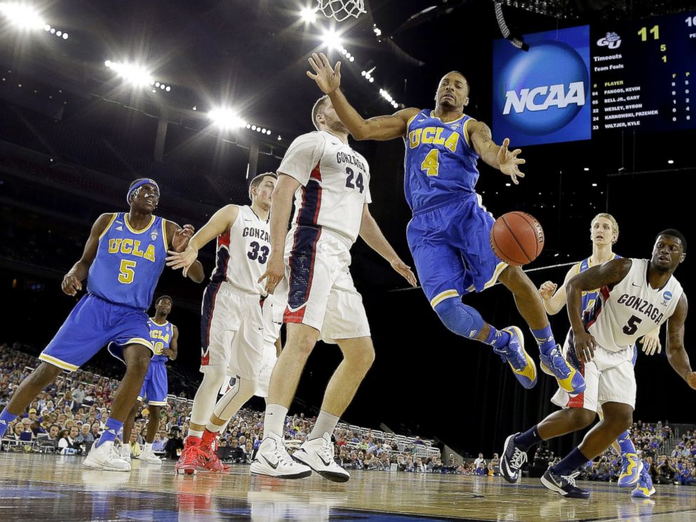 PHOTO: UCLAs Norman Powell (4) loses the ball in front of Gonzagas Przemek Karnowski (24) during the first half of a college basketball regional semifinal game in the NCAA Tournament, March 27, 2015, in Houston.