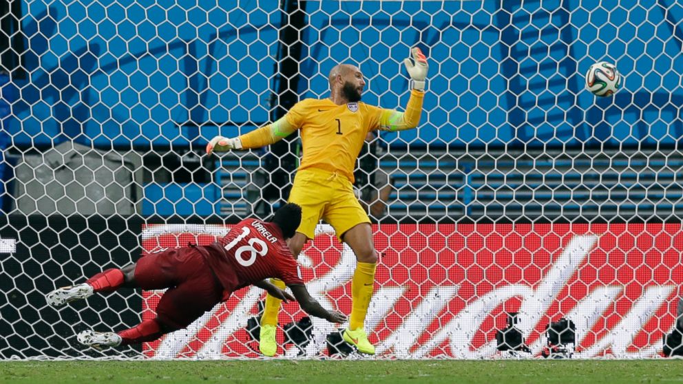 PHOTO: Portugals Silvestre Varela heads the ball past United States goalkeeper Tim Howard to score his sides second goal and tie the game 2-2 during the group G World Cup soccer match between the USA and Portugal at the Arena da Amazonia in Brazil.