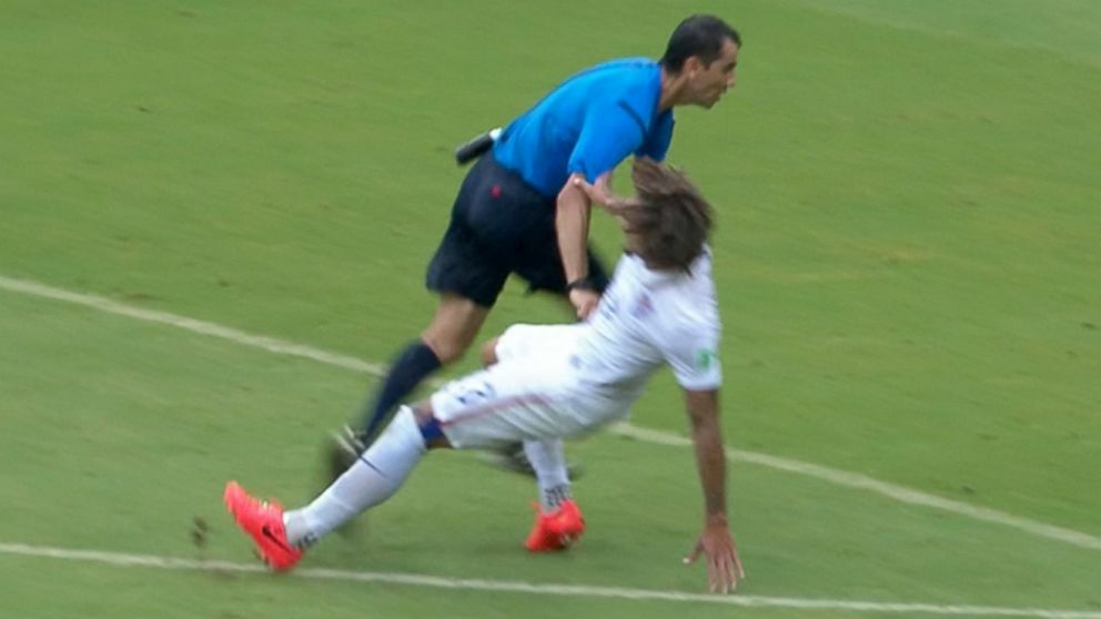 PHOTO: USA player Jermaine Jones collides with the ref during the first half of the USA vs. Germany match of the 2014 FIFA World Cup, June 26, 2014, in Brazil.