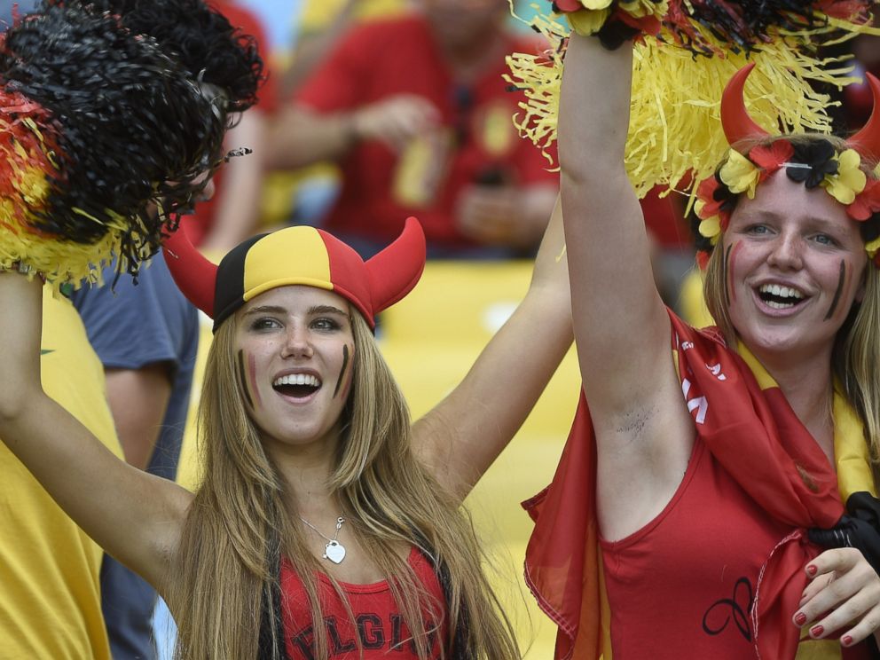 PHOTO: Axelle Despiegelaere, a Belgium supporter cheers with her friend as they wait for the start of the Group H football match between Belgium and Russia at the Maracana Stadium in Rio de Janeiro during the 2014 FIFA World Cup on June 22, 2014.