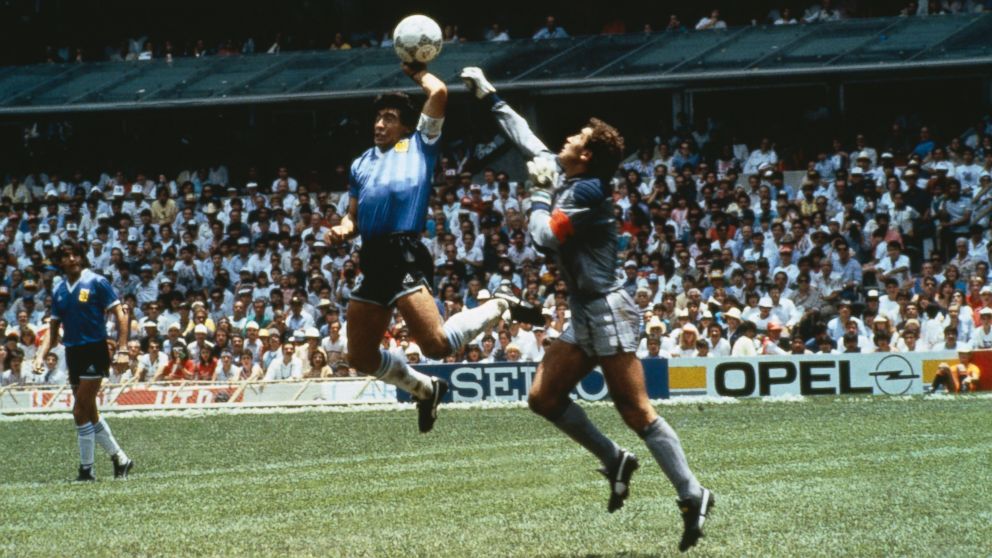 PHOTO: Argentinas Diego Maradona scores with his "Hand of God," past England goalkeeper Peter Shilton on June 22, 1986 in Mexico.