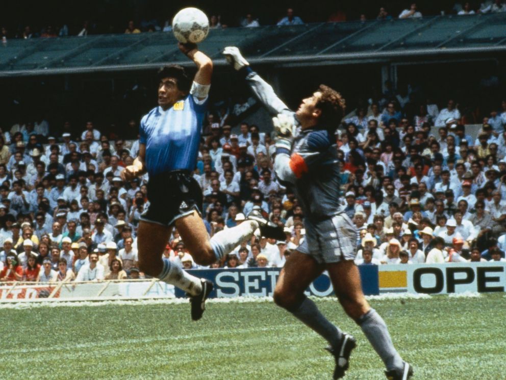 PHOTO: Argentinas Diego Maradona scores with his Hand of God, past England goalkeeper Peter Shilton on June 22, 1986 in Mexico.