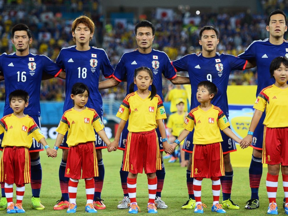PHOTO: Left to right, Hotaru Yamaguchi, Yuya Osako, Yasuyuki Konno, Shinji Okazaki and Maya Yoshida of Japan sing the National Anthem during the 2014 FIFA World Cup Brazil Group C match between Japan and Greece.