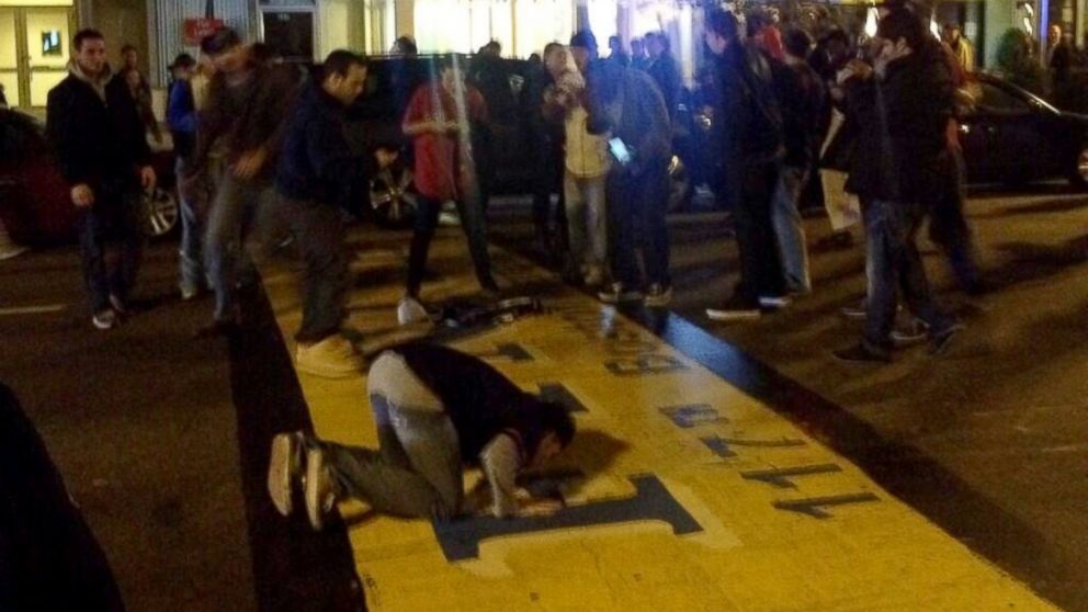PHOTO: Fans cheered and kissed the Boston Marathon finish line after the Red Sox won the World Series, Oct. 30, 2013, in Boston.