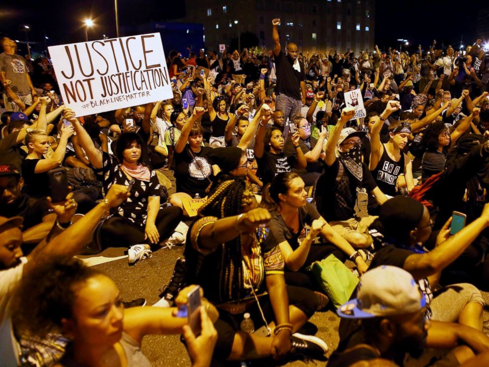 PHOTO: Protesters sit and hold a moment of silence for Keith Scott during another night of protests over the police shooting of Scott in Charlotte, North Carolina, Sept. 24, 2016