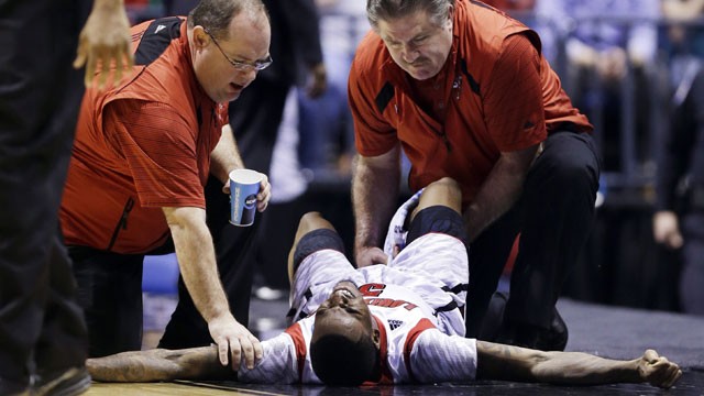 PHOTO: Trainers check on Louisville guard Kevin Ware (5) after Ware injured his lower right leg during the first half of the Midwest Regional final against Duke in the NCAA college basketball tournament, Sunday, March 31, 2013, in Indianapolis.