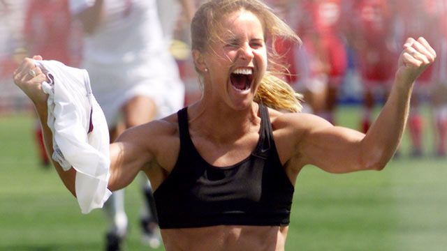 PHOTO: Brandi Chastain of the US shouts after falling on her knees after she scored the last goal in a shoot-out in the finals of the Women's World Cup with China at the Rose Bowl in Pasadena, California 10 July 1999.