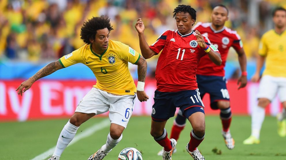PHOTO: Marcelo of Brazil is challenged by Juan Guillermo Cuadrado of Colombia during the 2014 FIFA World Cup Brazil match between Brazil and Colombia at Castelao on July 4, 2014 in Fortaleza, Brazil.