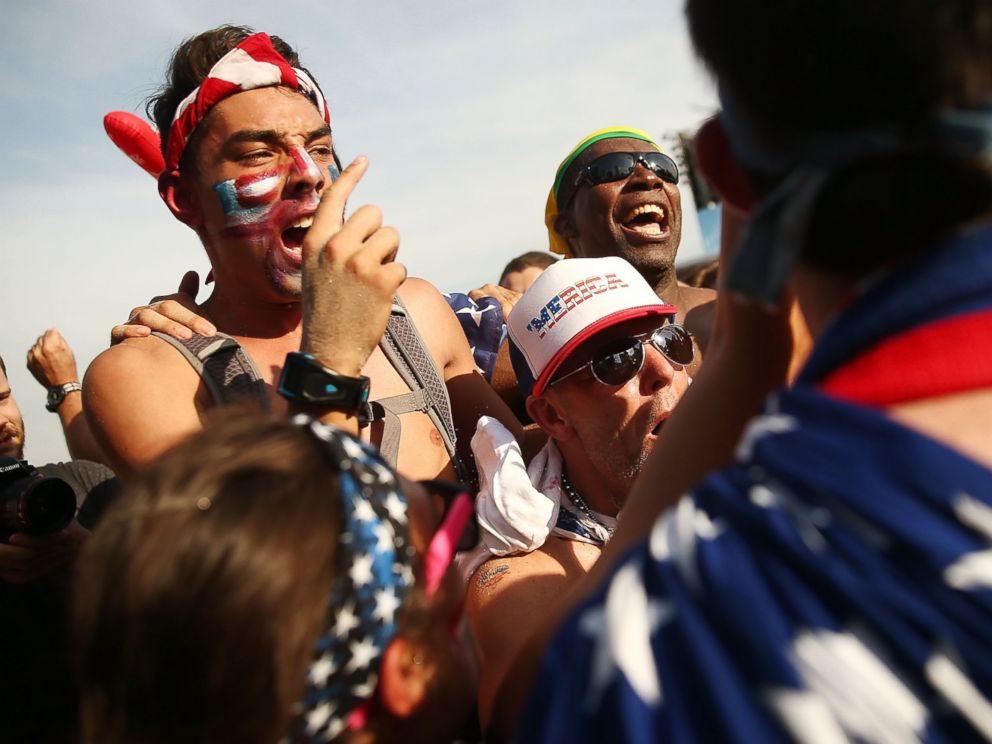 PHOTO: U.S. supporters celebrate advancing to the Round of 16 after their loss to Germany while watching the match at FIFA Fan Fest on June 26, 2014 in Rio de Janeiro, Brazil.