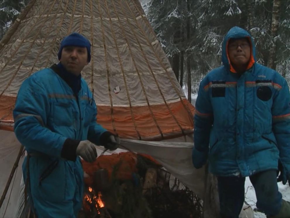PHOTO: The simulated crash landing involved the crew -- including U.S. astronaut Randolf Breznik (left) and Japanese astronaut Norishige Kanai (right) -- creating a teepee tent using the spacecrafts parachute.