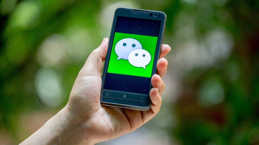 PHOTO: A Chinese man uses mobile messaging app Weixin, or WeChat, of Tencent on his smartphone in Guangzhou city, south Chinas Guangdong province, Aug. 15, 2013.