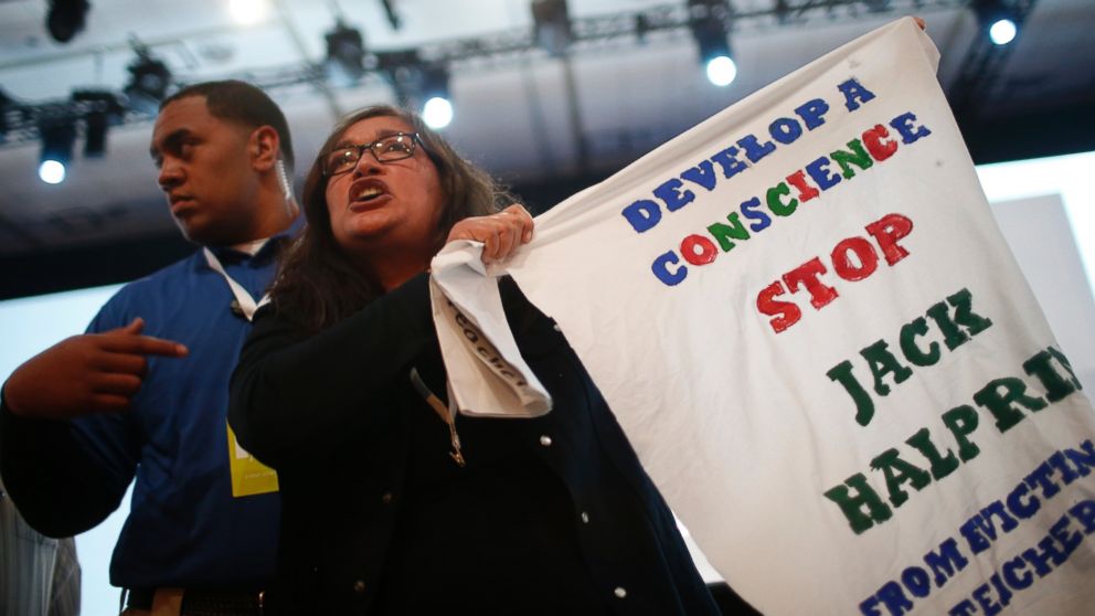 PHOTO: A demonstrator waves a sign in protest of Google during the Google I/O Developers Conference