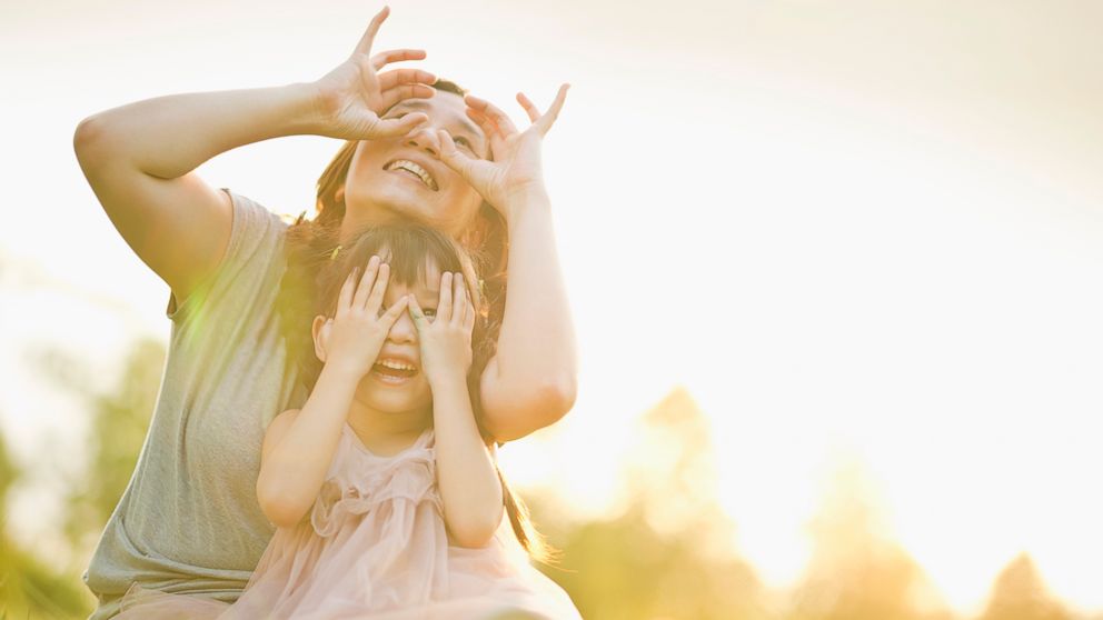 PHOTO: A mother and child play under sunset.