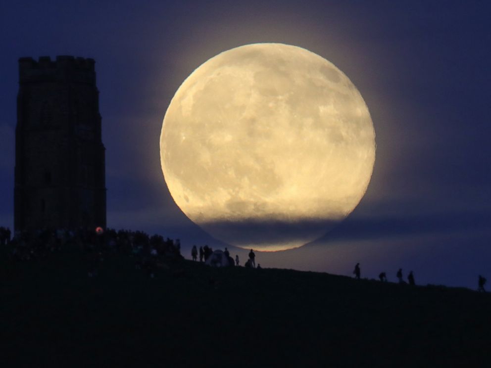 PHOTO: A full moon rises behind Glastonbury Tor as people gather to celebrate the summer solstice, June 20, 2016, in Somerset, England.