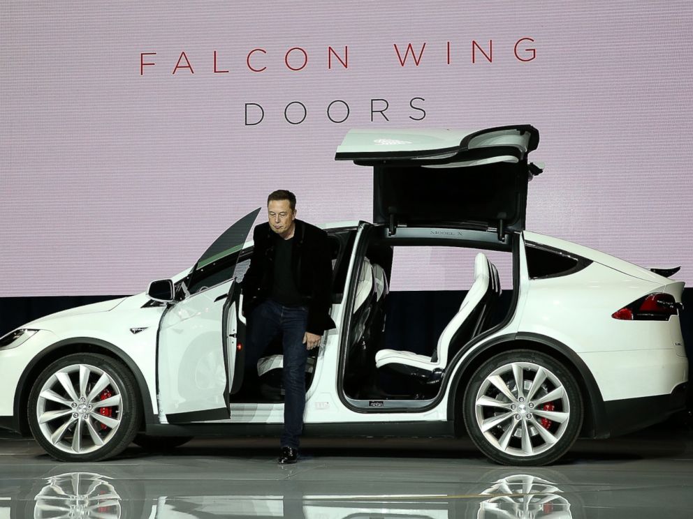 PHOTO: Elon Musk demonstrates the falcon wing doors on the new Tesla Model X Crossover SUV during a launch event on Sep. 29, 2015 in Fremont, California.