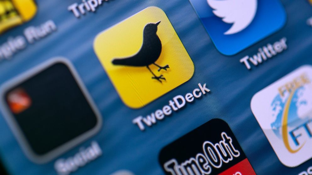 PHOTO: Logos for Twitter Inc.s TweetDeck app, center left, and Twitter app, center right, are seen on the screen of an Apple Inc. iPhone in this arranged photograph taken in London, May 7, 2013.
