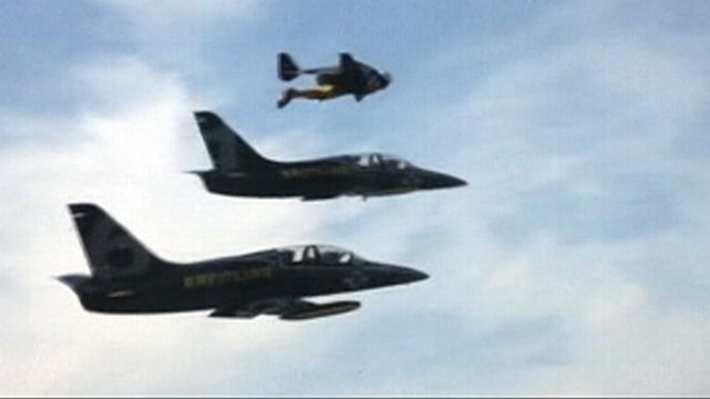 VIDEO: Swiss pilot Yves Rossy completes formation flight alongside two jets.
