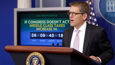 PHOTO: A middle class tax increase countdown clock is seen behind White House Press Secretary Jay Carney as he briefs reporters after President Barack Obama made a statement in the Press Briefing Room of the White House on Dec. 5, 2011.