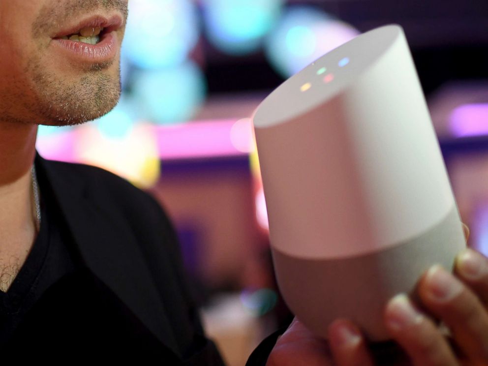 PHOTO: A young man shows the features of a Google Assistant speaker at an exhibition in Berlin, Sept. 1, 2017.