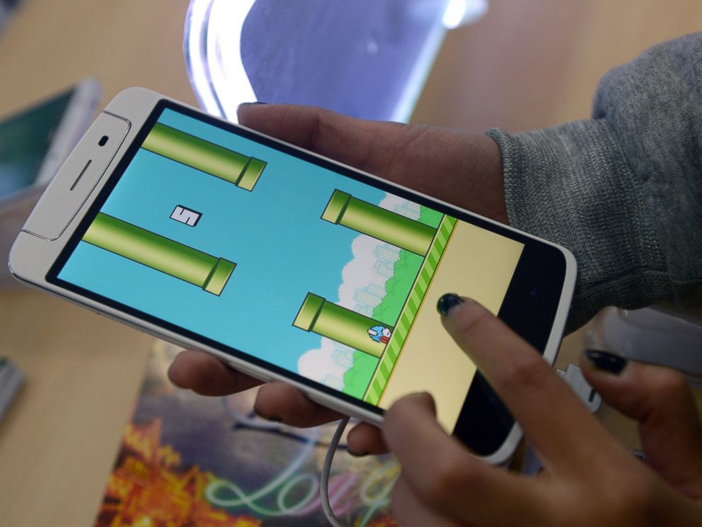PHOTO: An employee plays the game Flappy Bird at a smartphone store in Hanoi on Feb. 10, 2014.